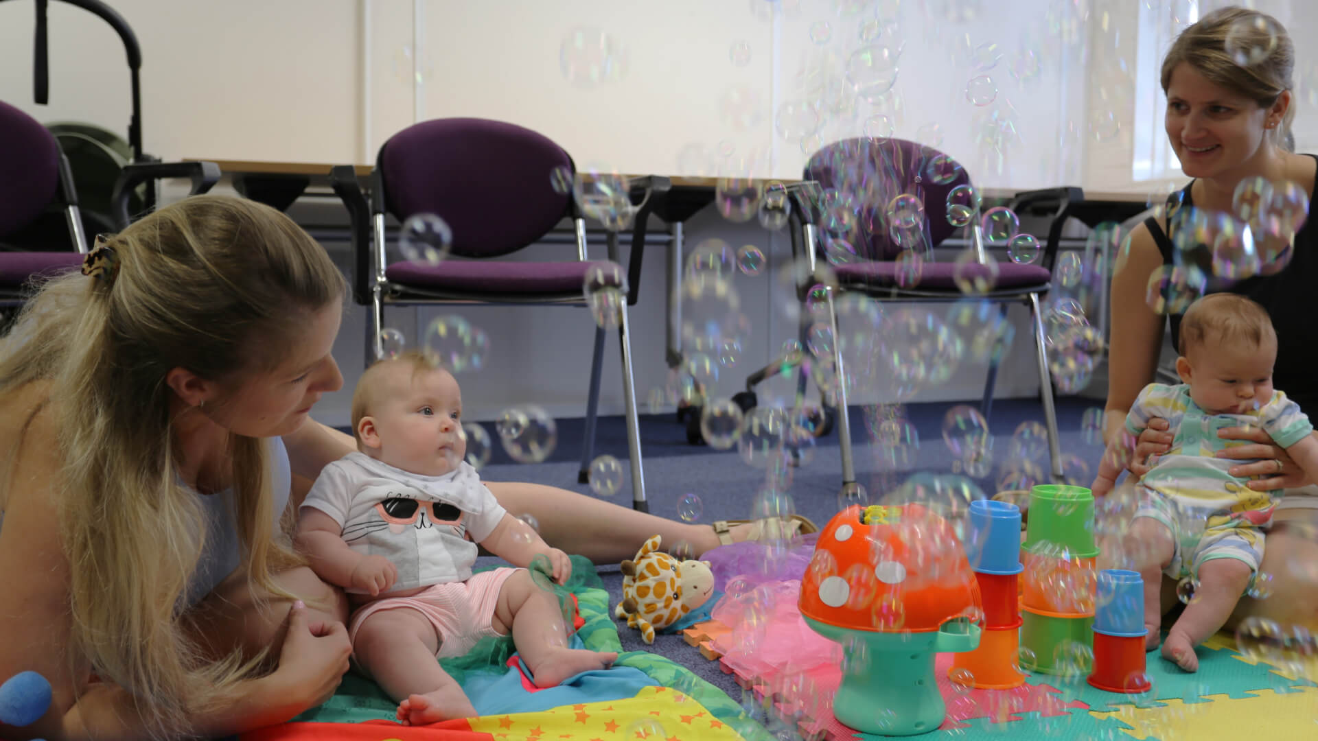 mum and baby with sensory toys