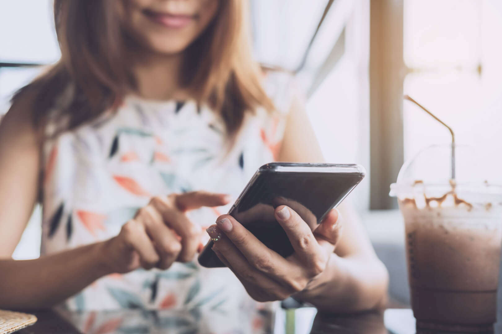 woman using smartphone in cafe