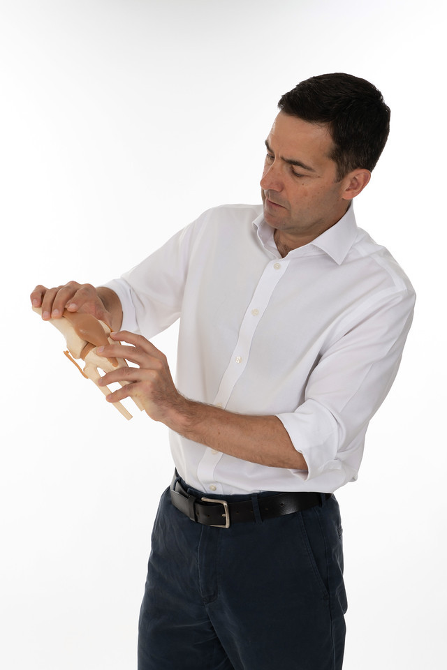 nick hancock looking at a knee joint model