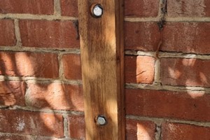 Wall mounted posts should only be used when the wall is structurally sound. The best fixing to use are anchor bolts but they should not be used on or close to an edge, top bricks or corner edge due to risk of splitting the brick