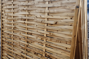 A pressure treated panel that comprises of a series of narrow thin slats woven between 3 vertical rails fixed securely in a rebated framed wooden panel. 