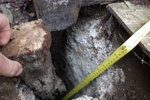 A Rotten wooden post repair below ground level needs removing, reuse the wooden post section above ground. Remove wood decay & treat with a rot hardener and fungicide over the affected areas.