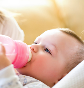 little girl having trouble drinking milk from a bottle 