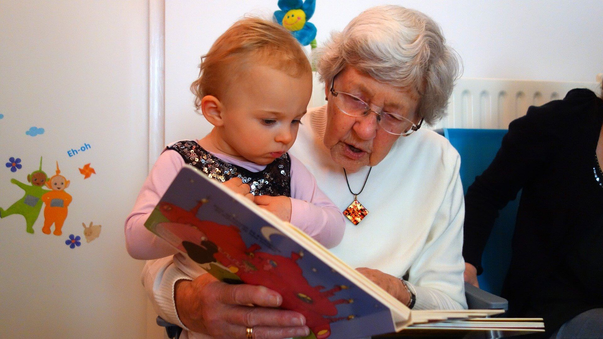 kid reading with grandma