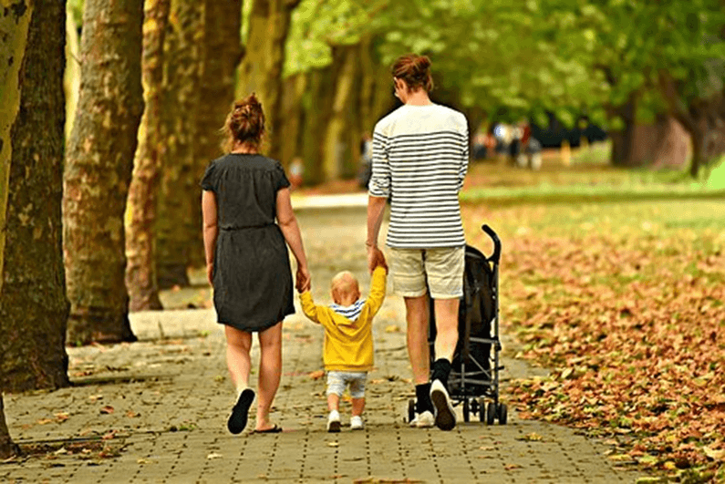 parents with a baby in the park