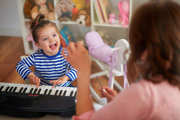 kid playing on a piano