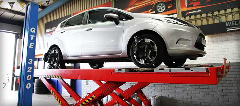 mechanic checking under car