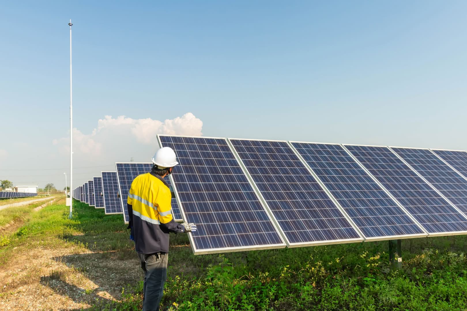 Solar worker inspecting panels