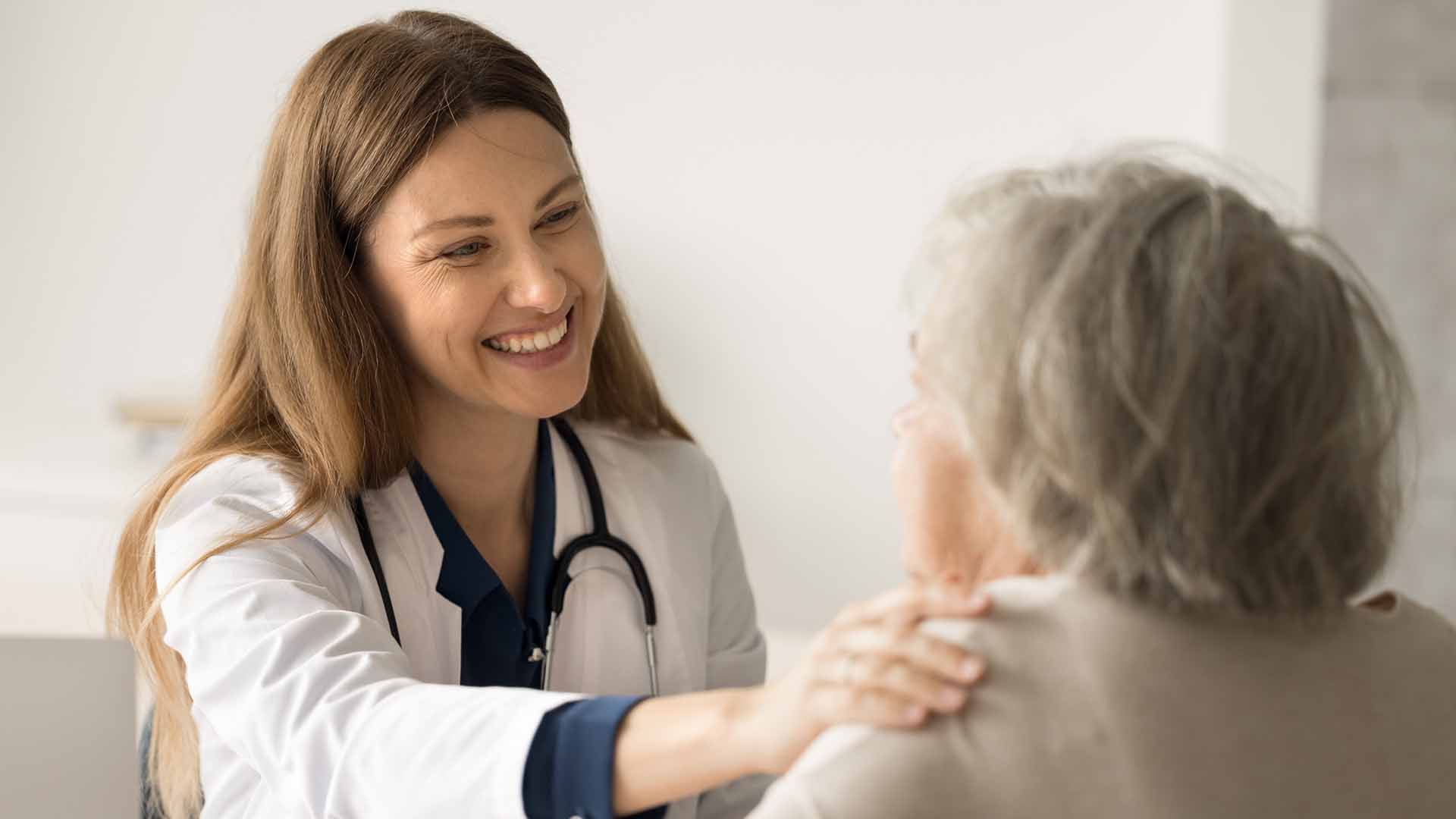 Care worker with old woman