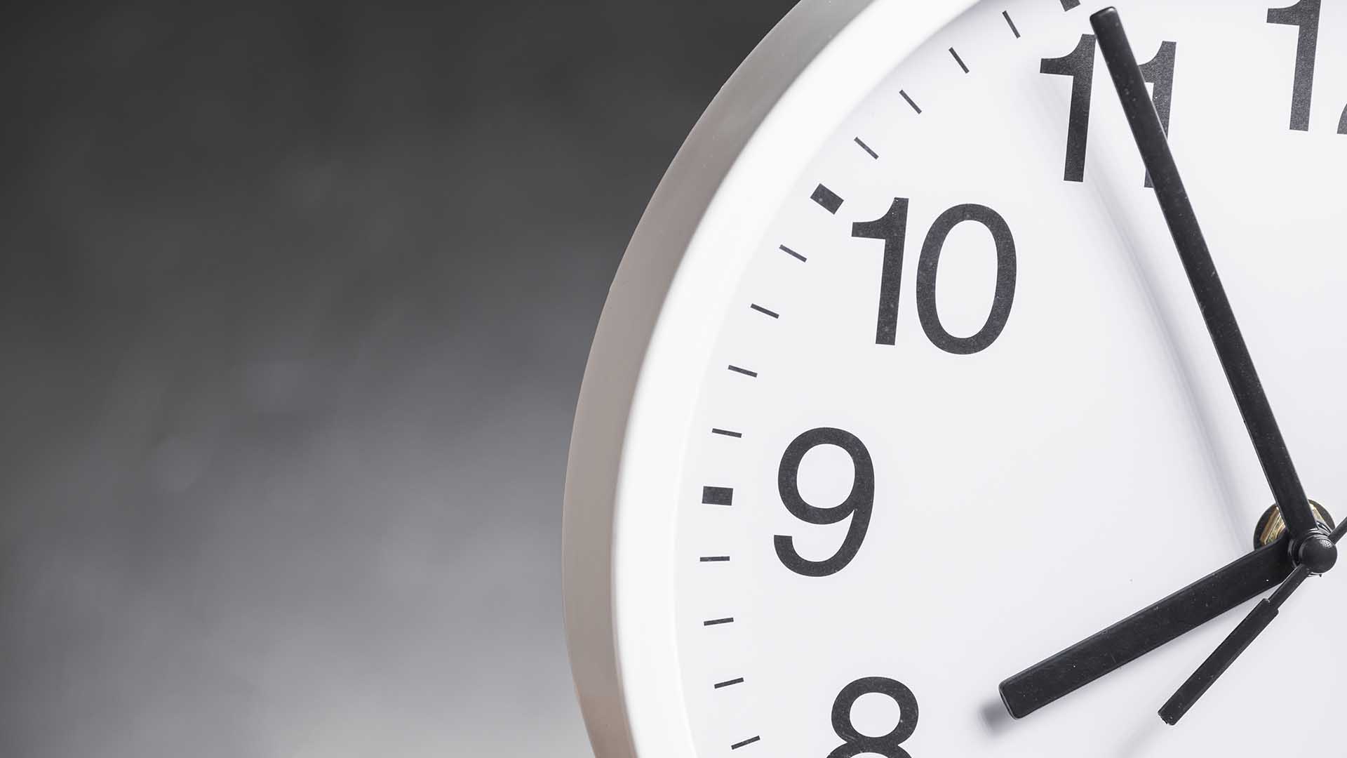 Close up clock face against gray background