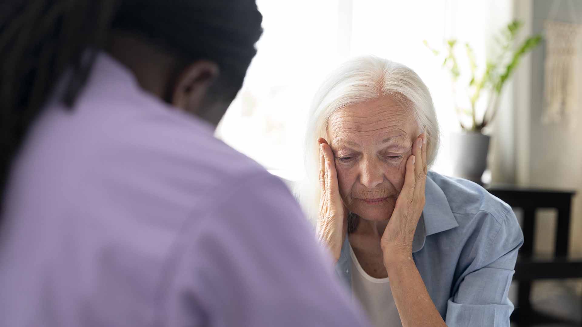 Social worker taking care senior woman
