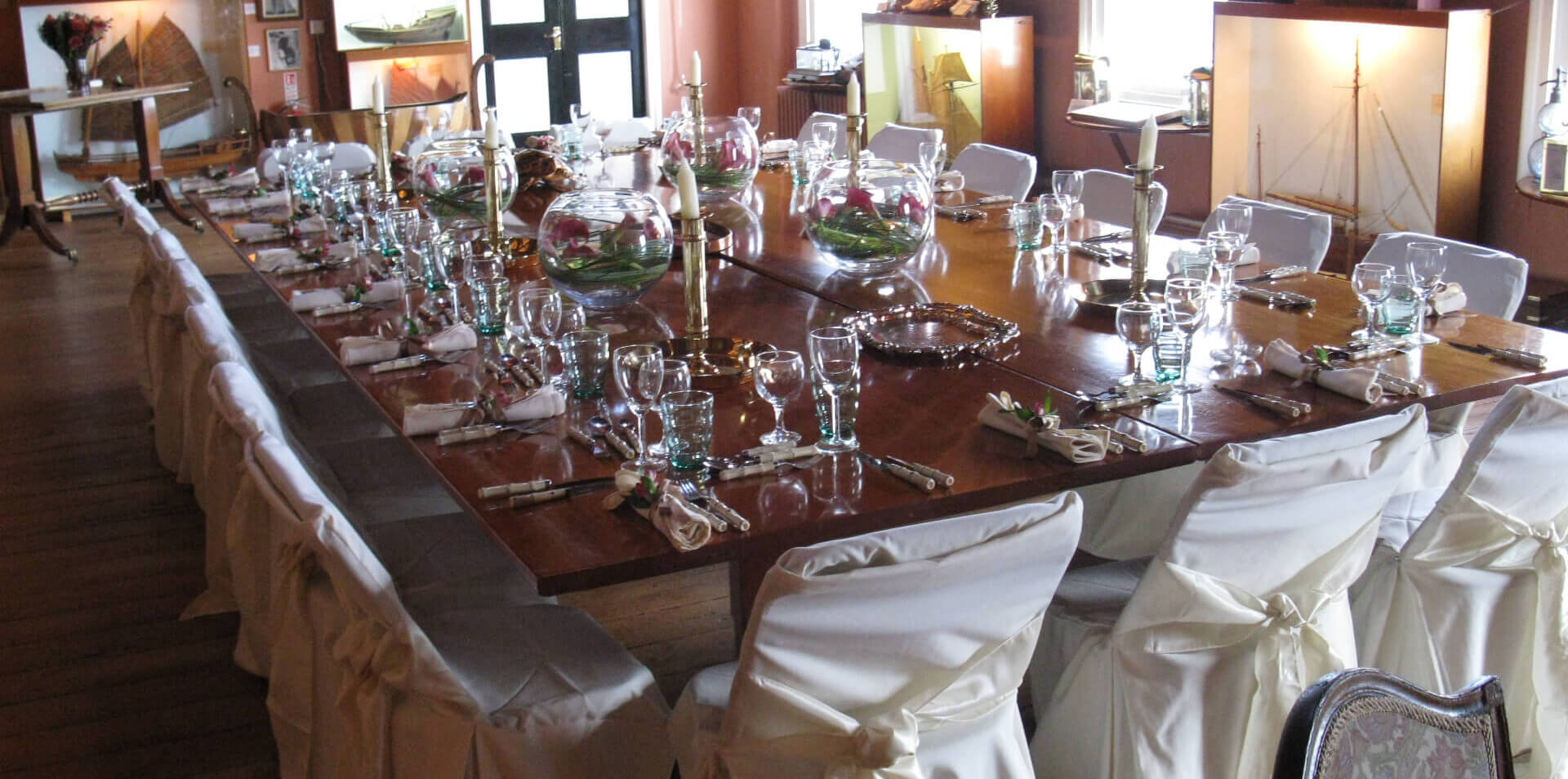 big wooden table set up for a wedding on a ship