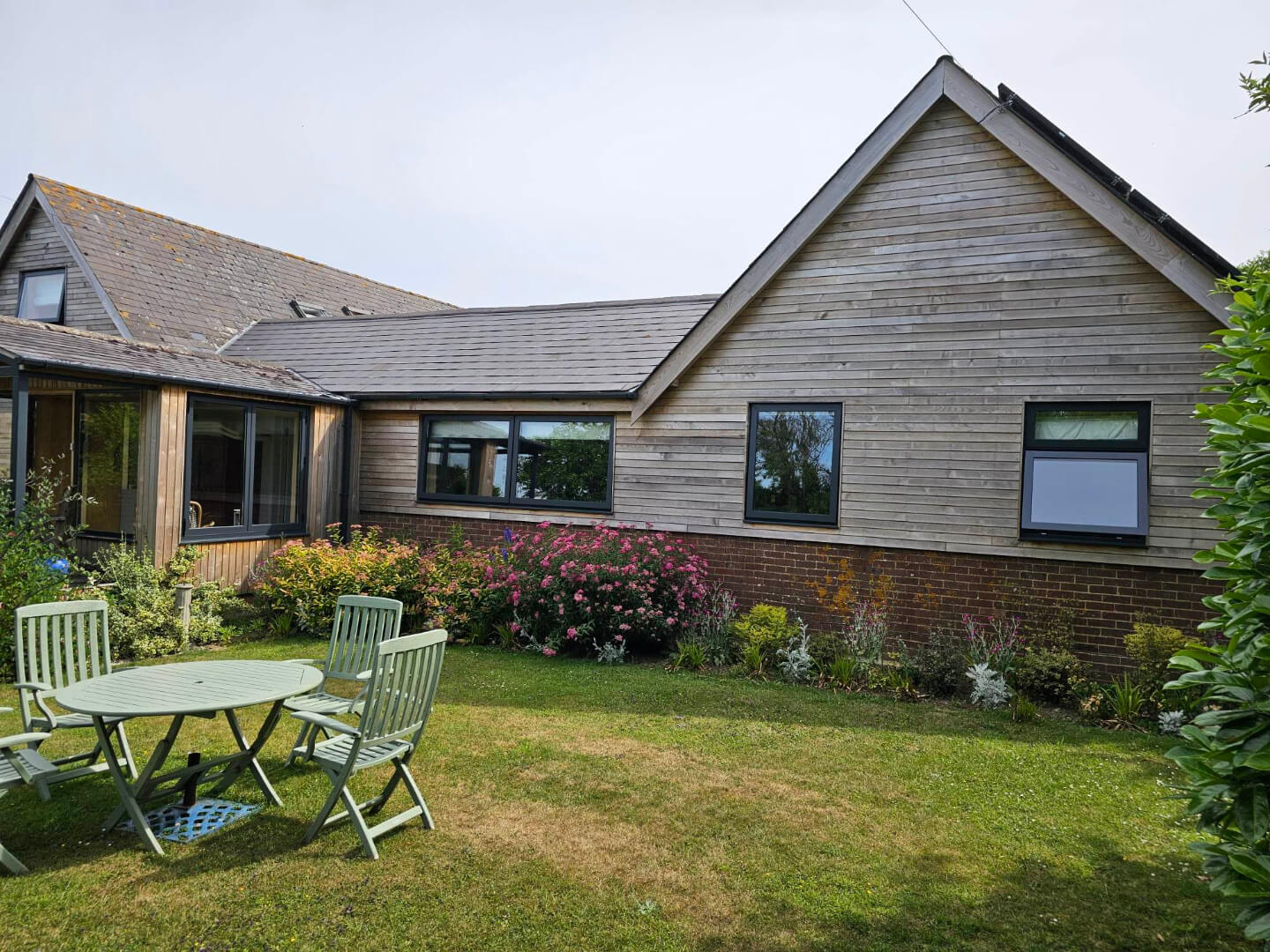 wood house with windows and garden