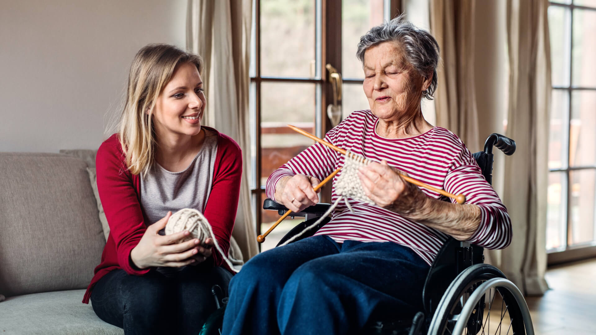 Carer and woman knitting