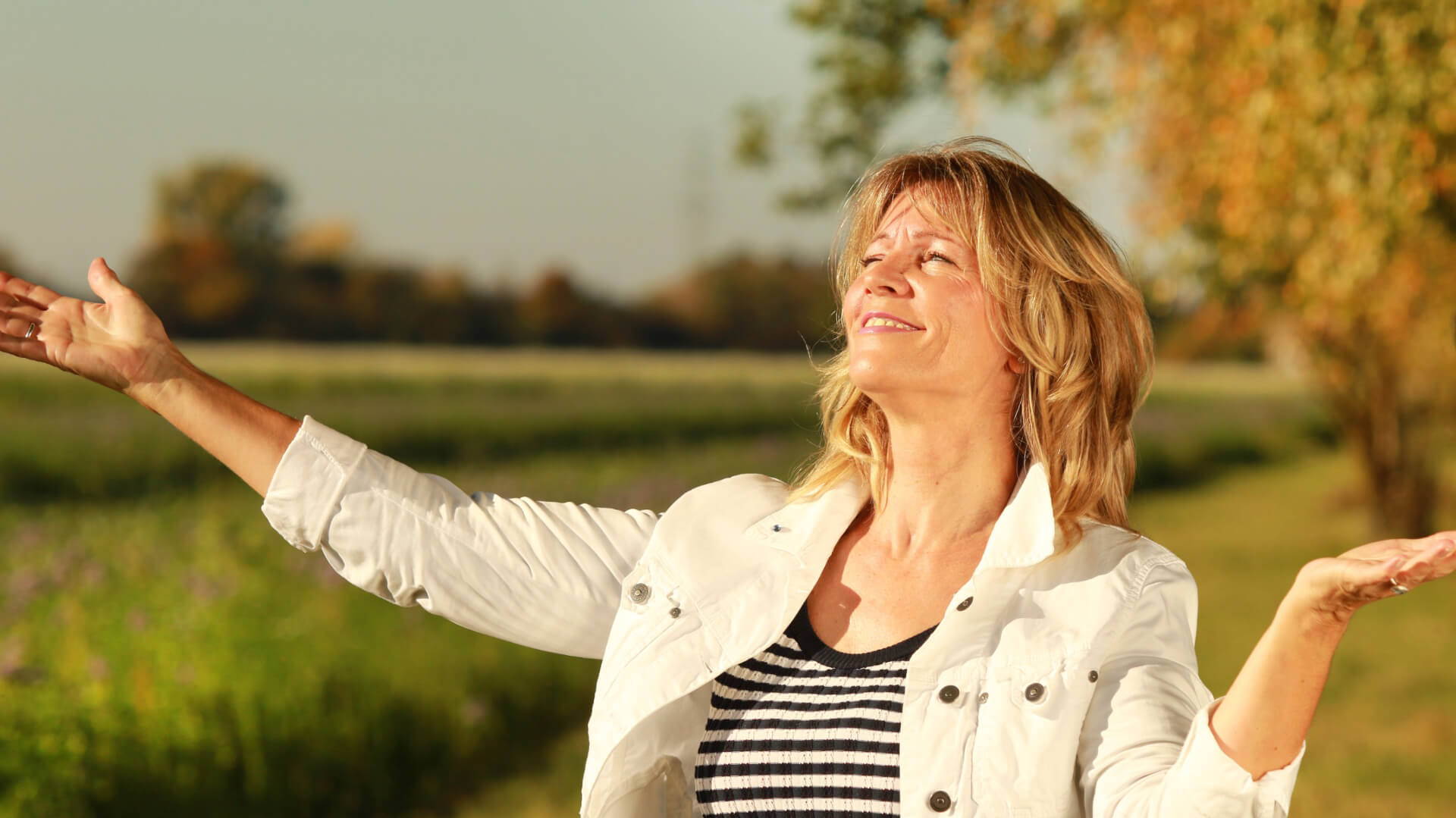 Happy woman with arms up