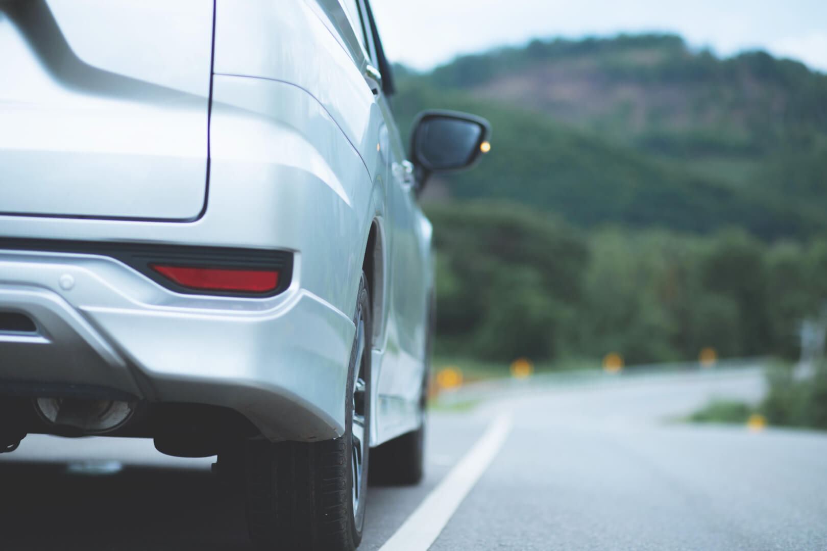 Silver car on road close up