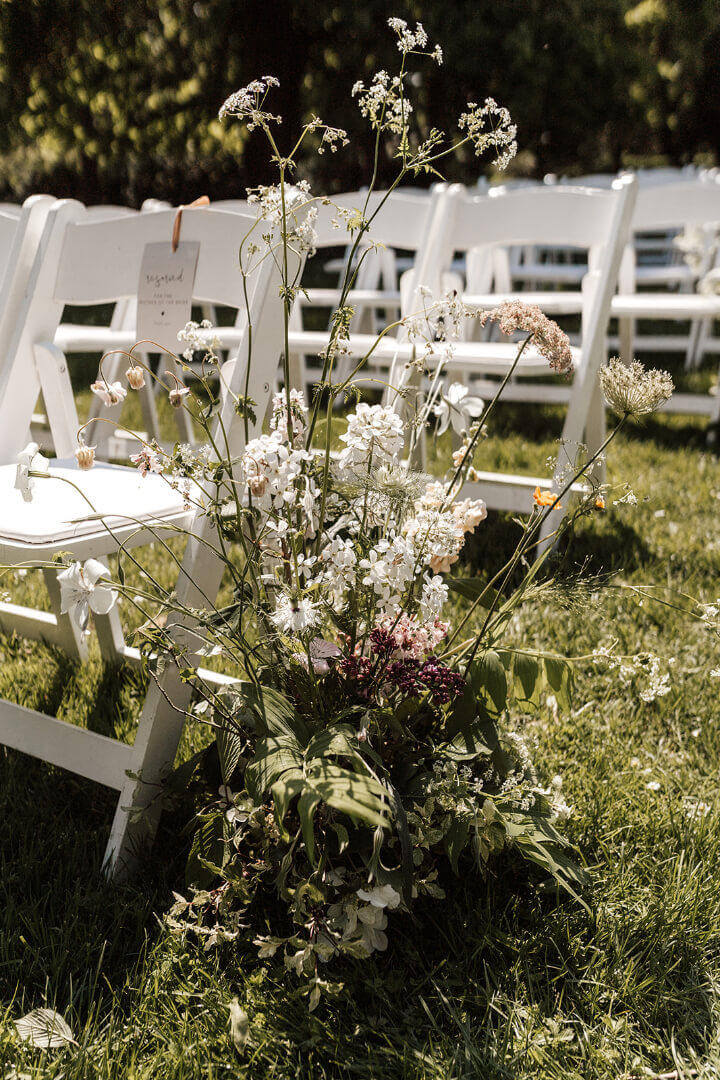 flowers by white fold chairs