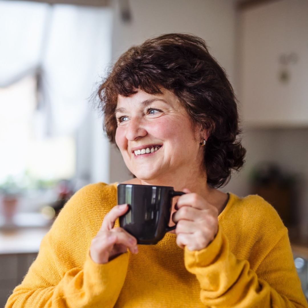 Happy senior woman with cup