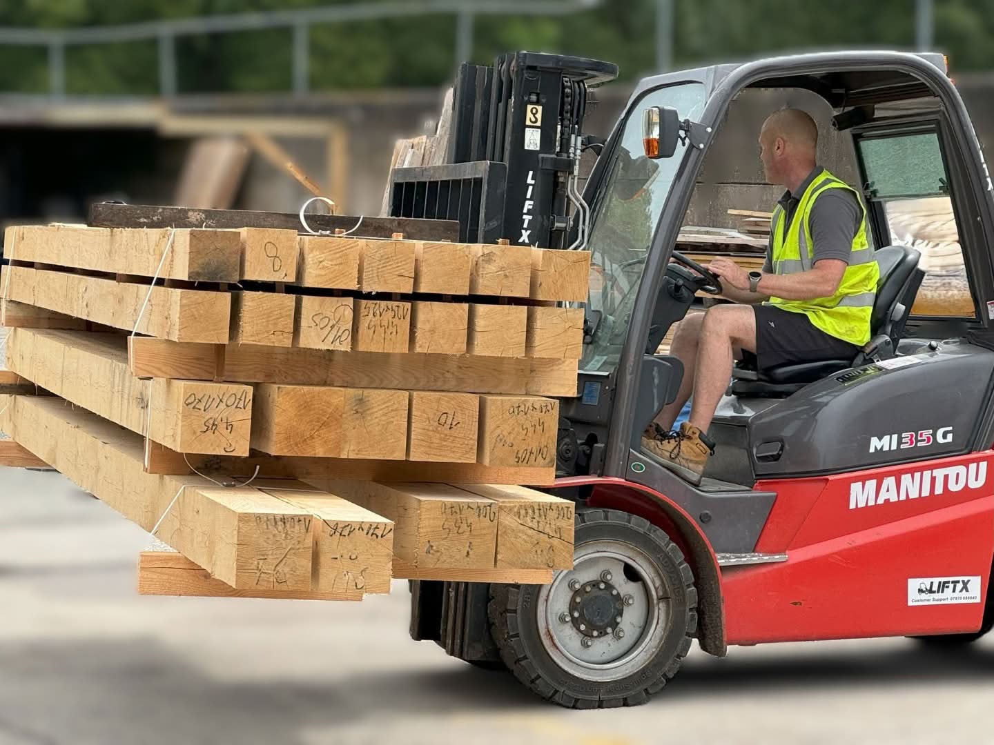 Forklift truck green oak beams stock