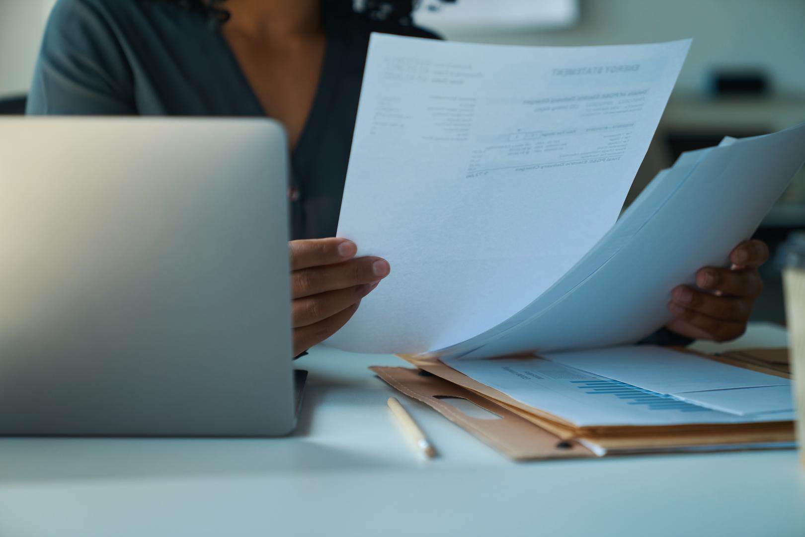 Woman at desk checking documents