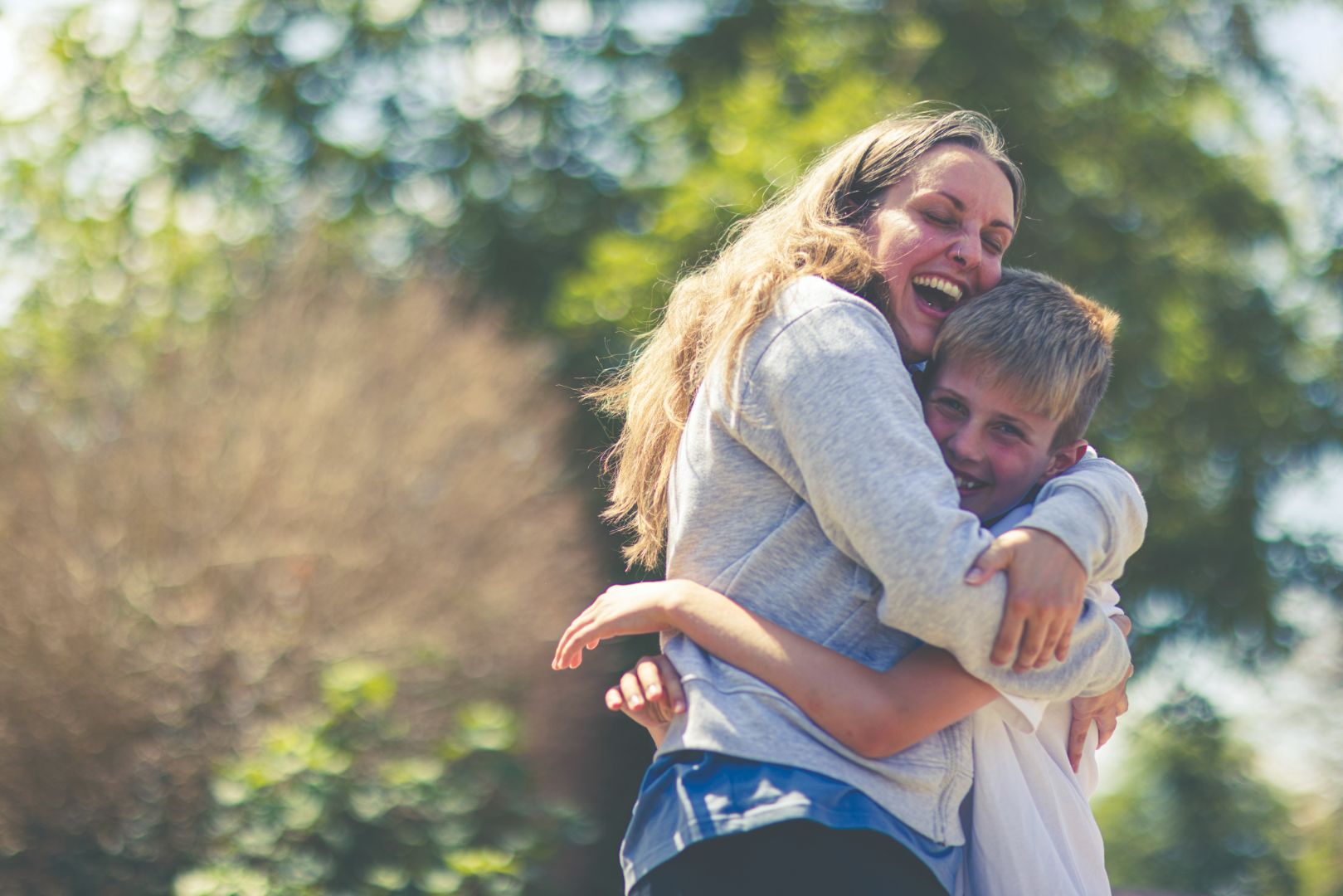 Happy mother and boy in the garden