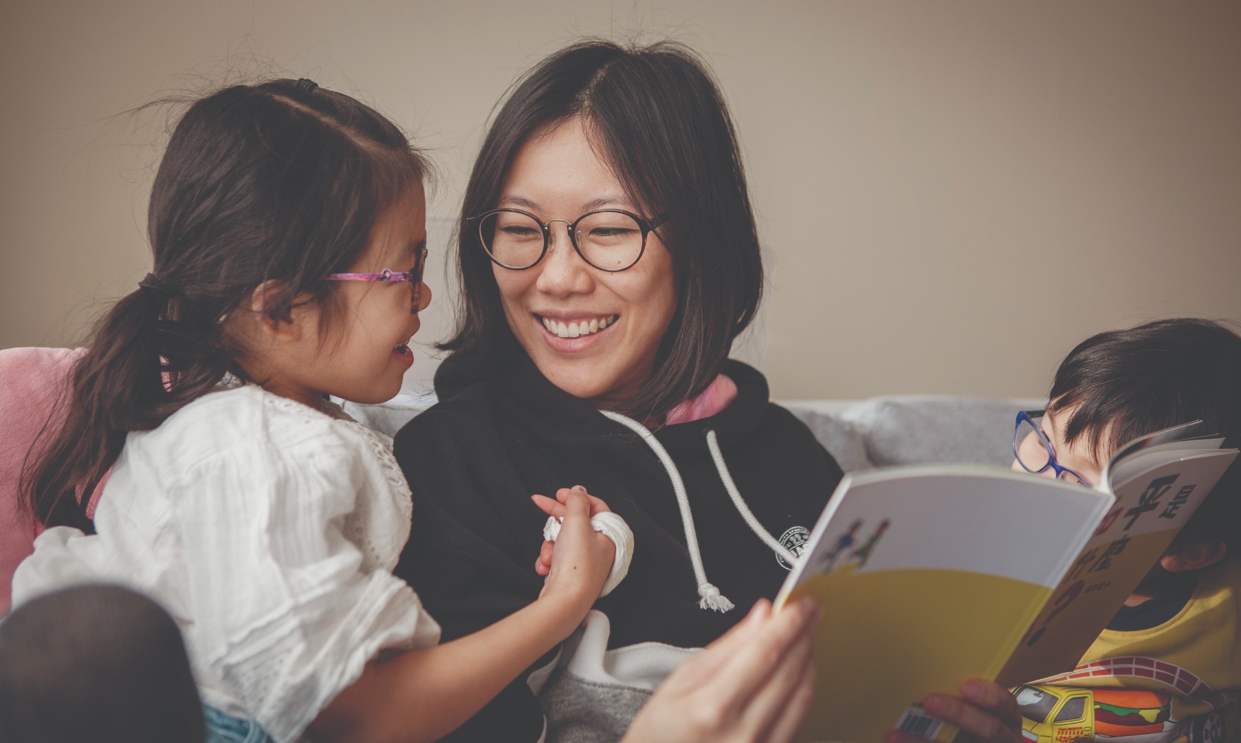 Mother with children reading a book