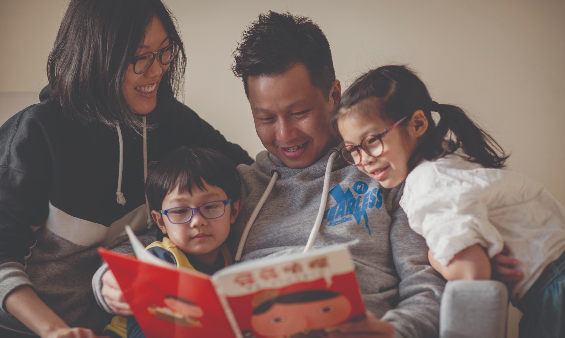 Parents with children reading a book