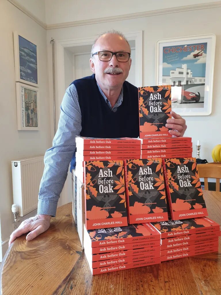 John hall with a stack of ash before oak book