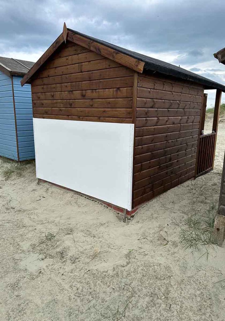 Dark brown wood shed on the beach