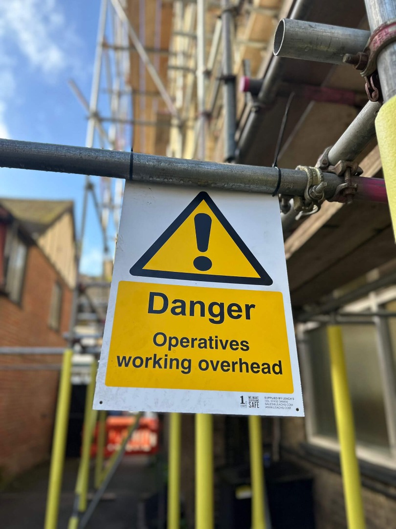 Operatives working overhead sign