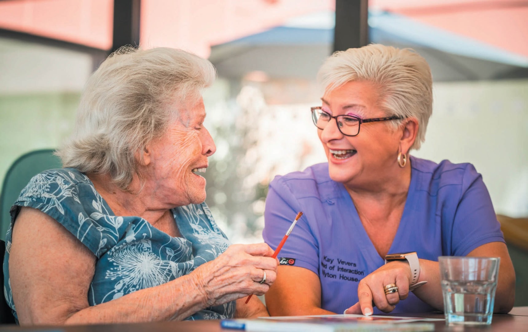 Woman and carer laughing