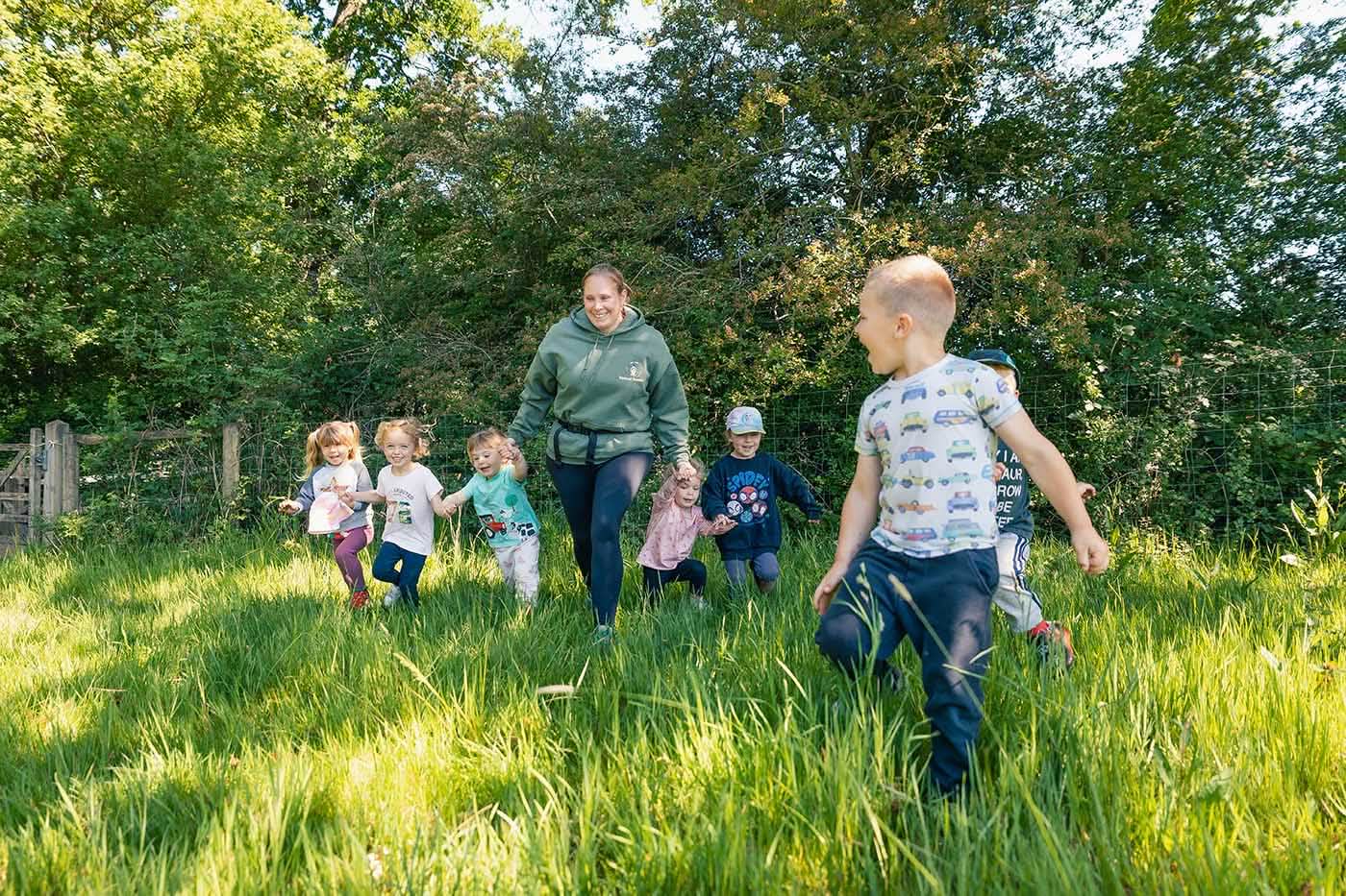 Children running with a woman