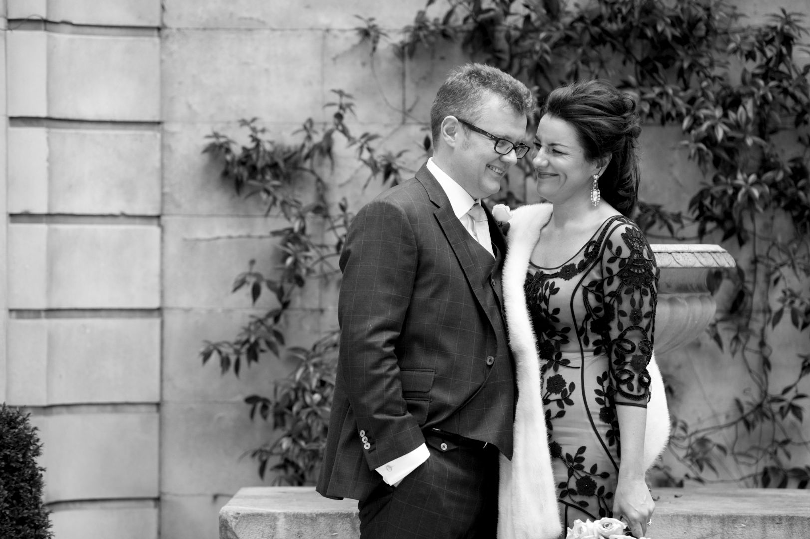 Bride and groom embrace greyscale