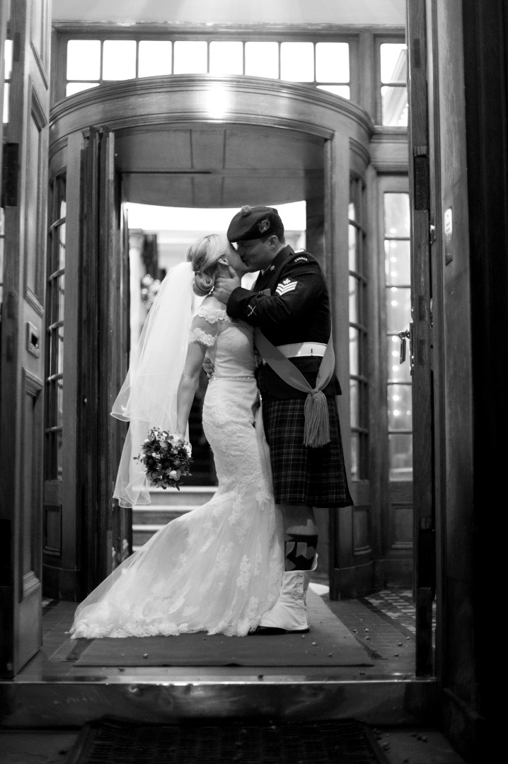 Bride and groom in doorway greyscale