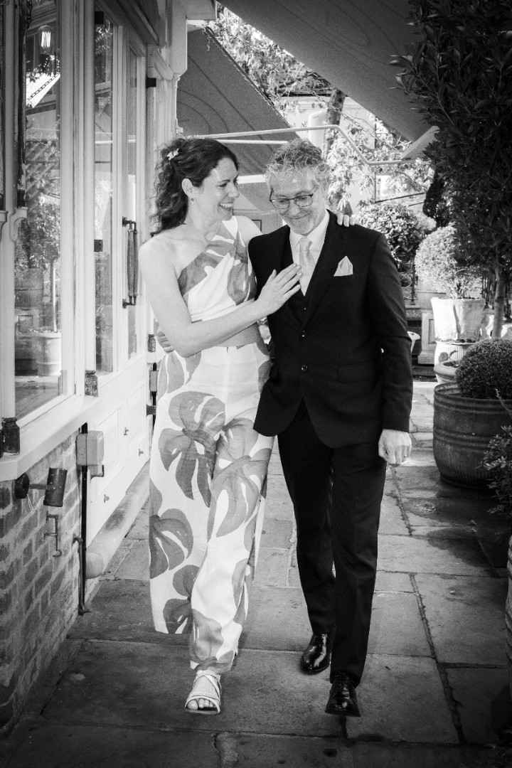 Groom arm around bride natural greyscale