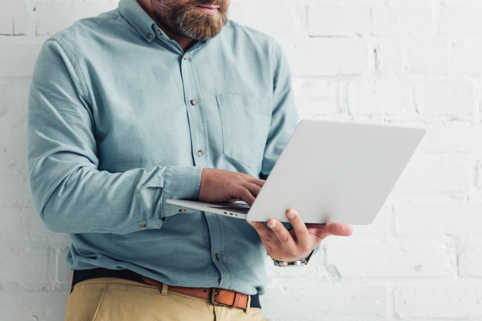 Businessman in shirt holding laptop