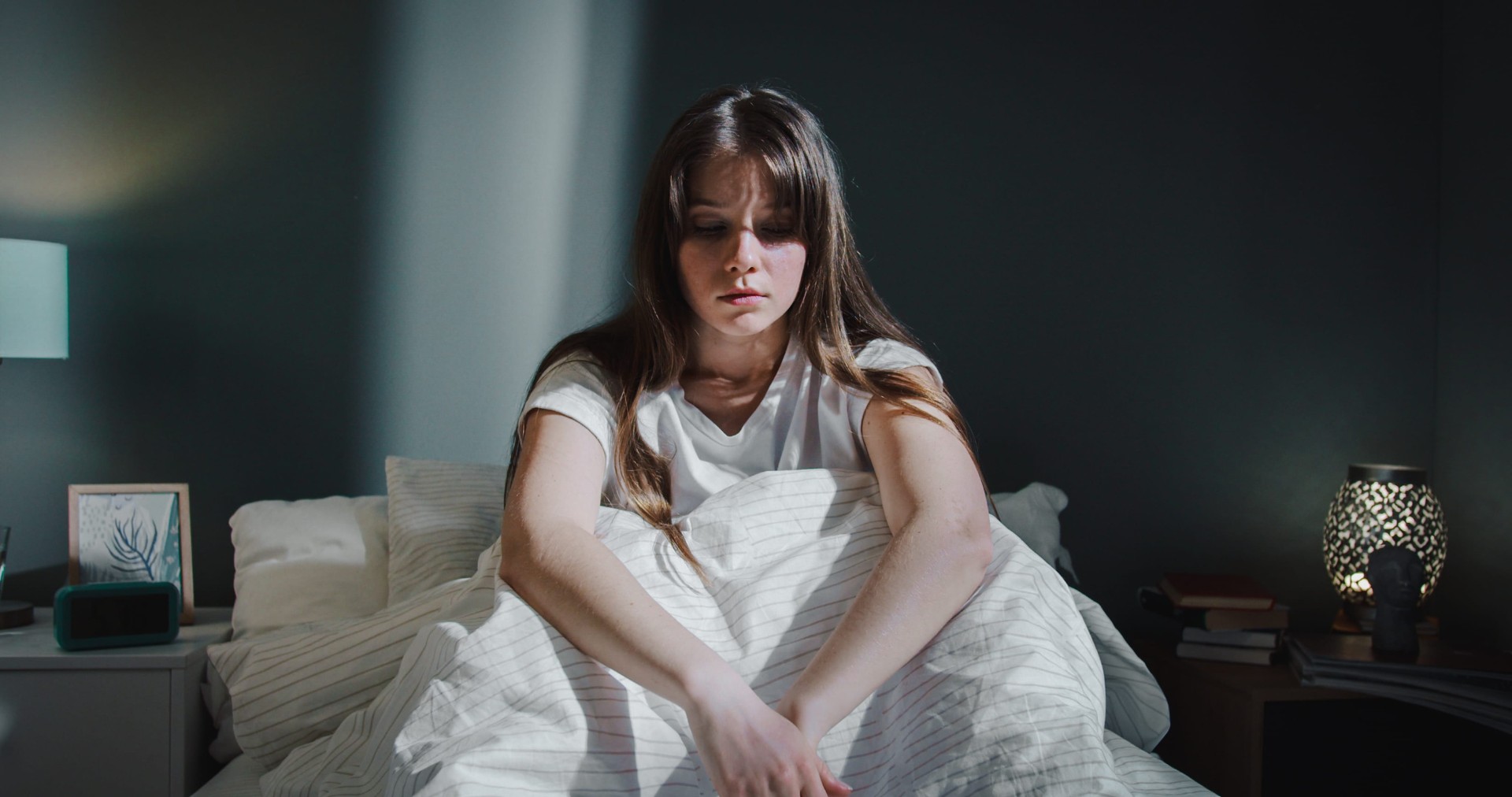 Beautiful woman sitting on bed