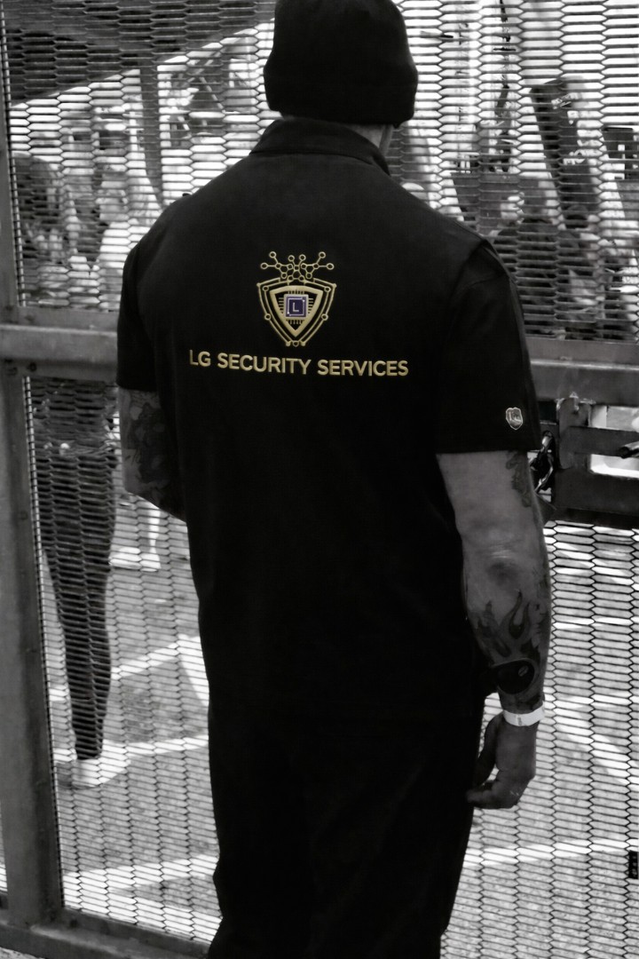 Lg security man behind fence
