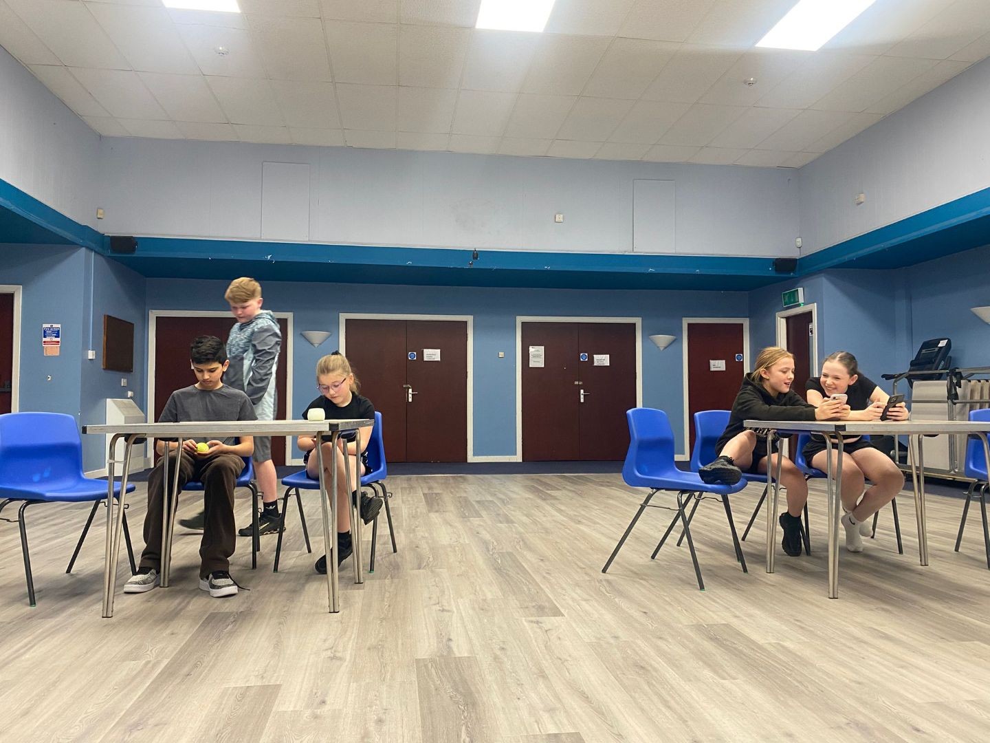 Children rest sitting at tables