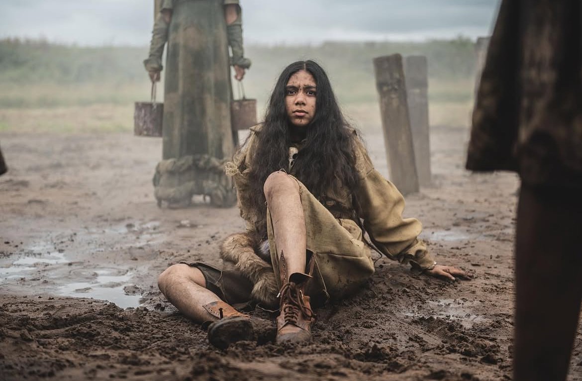 girl lying in the mud