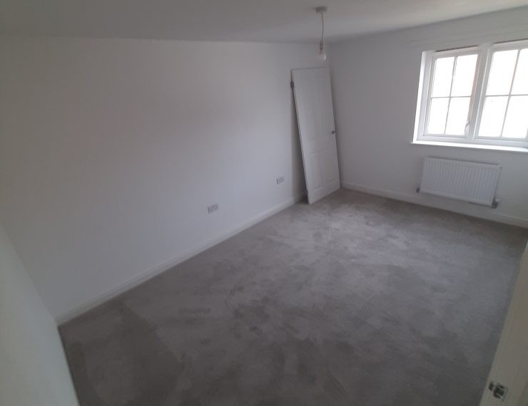 Empty room door against wall