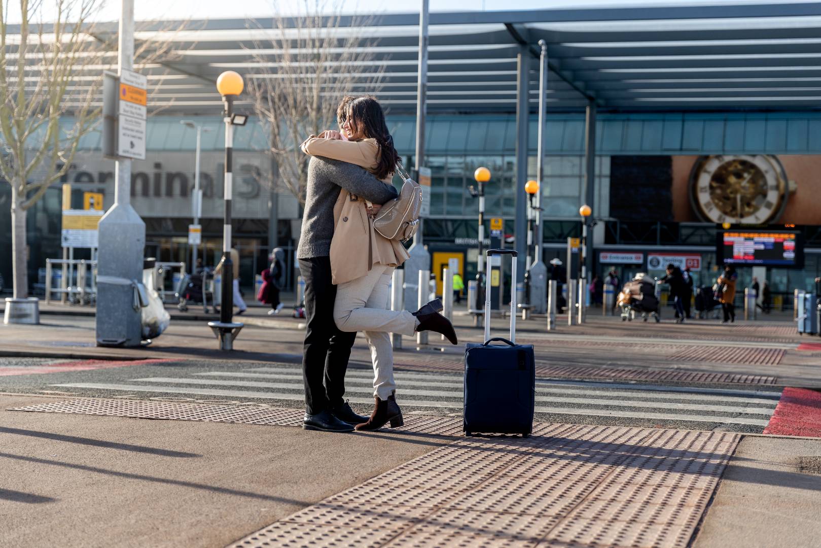 Full shot couple hugging outdoors