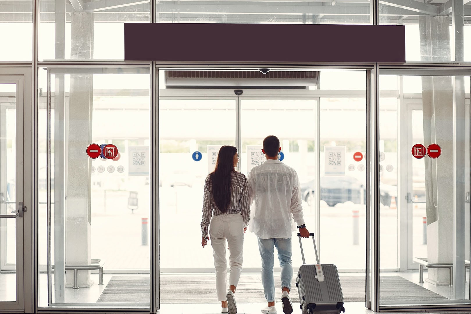 Happy couple leaving the airport