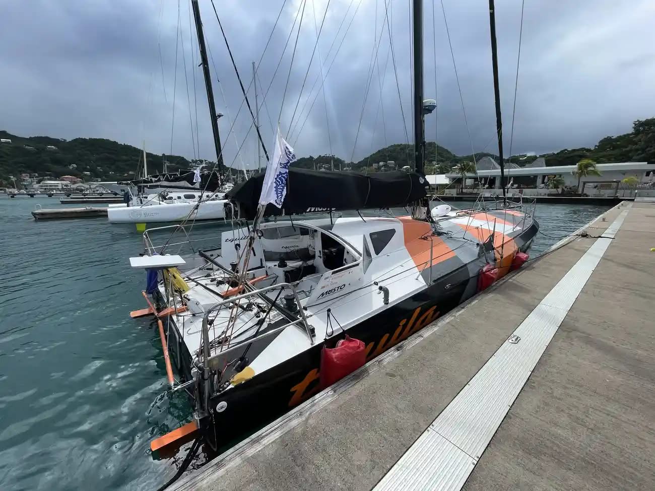 High-performance Mach 40.4 scow bow ocean racing yacht, designed by Sam Manuard pictured on her berth.  The deep cockpit and coachroof provide an excellent working platform, with winches and sail controls positioned for efficient sail handling and offering enhanced protection to the skipper and crew.