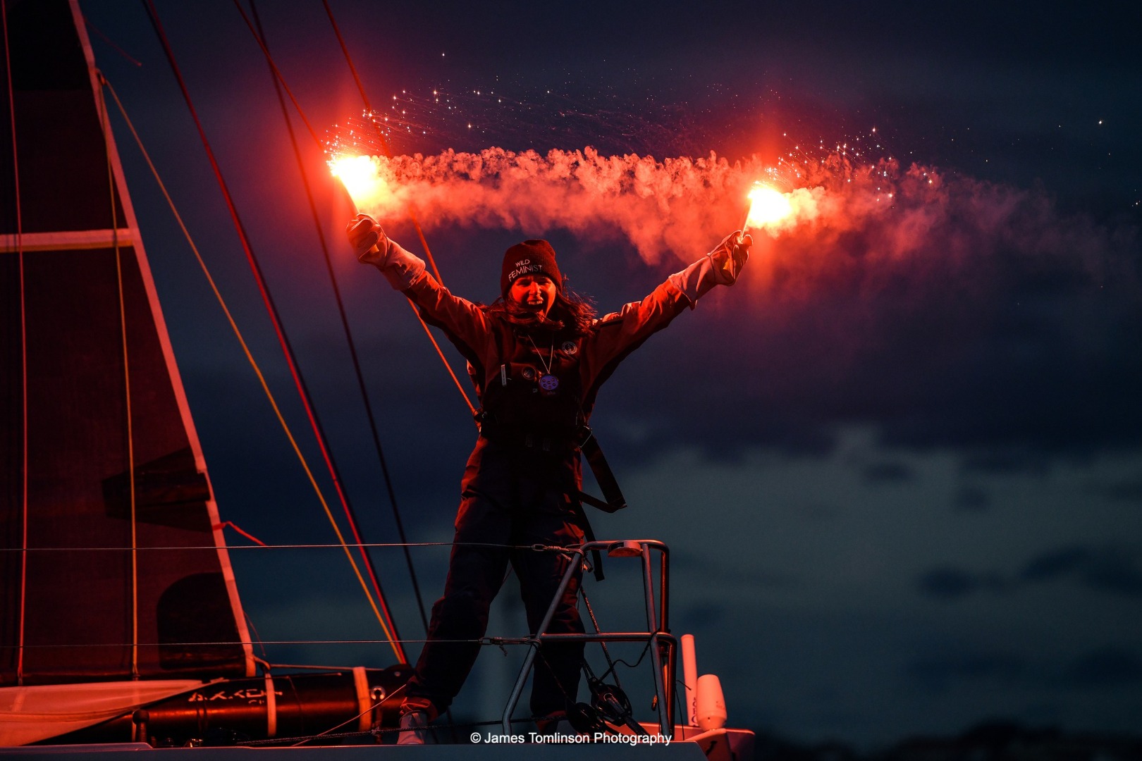 Image of Cole Brauer finishing the Global Solo Challenge, the first American woman to complete a solo race around the world non-stop, sailing First Light (ex Dragon), her Owen Clarke Design Class 40.