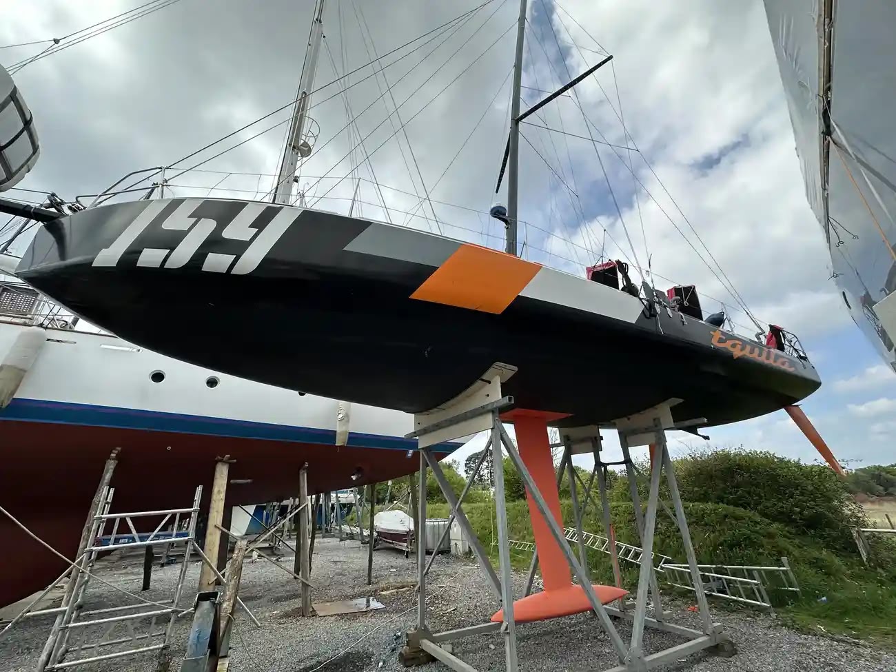 High-performance Mach 40.4 scow bow ocean racing yacht, pictured ashore. Her wide forward sections deliver exceptional stability, and impressive performance. Equipped for serious single-handed and double-handed offshore racing. Consistent race results, podium places, a proven, competitive and highly capable Class 40.