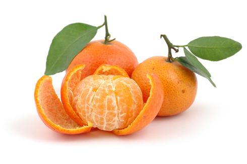 Pile of fresh tangerines in isolated white background