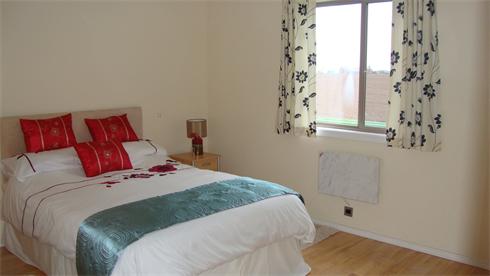 Double bedroom with large wardrobes.
Views across the field to the sea
