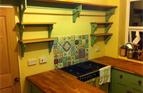 Oak shelves with painted pine bracketry to match existing kitchen installation. Approx £800.