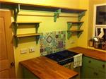 Oak shelves with painted pine bracketry to match existing kitchen installation. Approx £800.